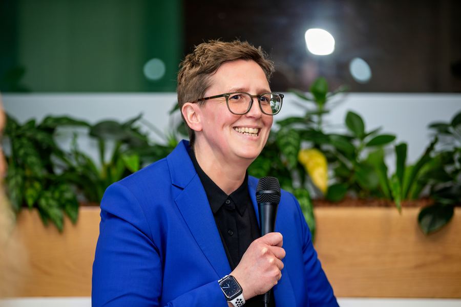 Kelly Canterford speaking with a microphone at an industry event